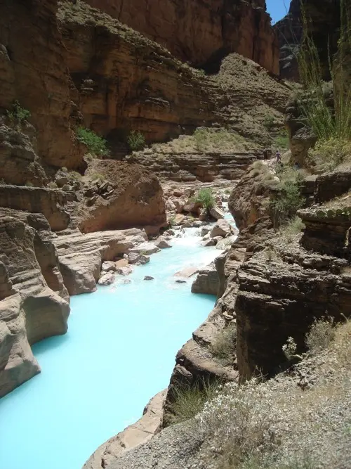 Havasu Falls cascading turquoise water over red rock cliffs