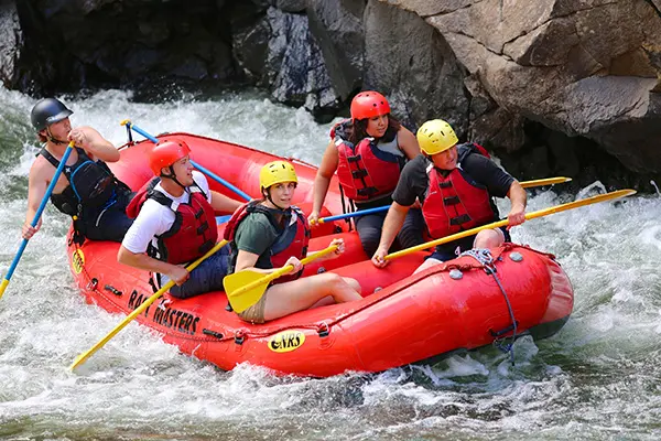 Rafters navigating a swift river bend